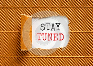 Stay tuned symbol. Concept words Stay tuned on beautiful white paper on a beautiful brown paper background. Business, support,