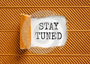 Stay tuned symbol. Concept words Stay tuned on beautiful white paper on a beautiful brown paper background. Business, support,