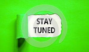 Stay tuned symbol. Concept words Stay tuned on beautiful white paper on a beautiful green background. Business, support,