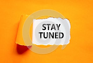 Stay tuned symbol. Concept words Stay tuned on beautiful white paper on a beautiful orange background. Business, support,