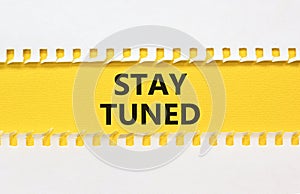 Stay tuned symbol. Concept words Stay tuned on beautiful yellow paper on beautiful white background. Business, support, motivation