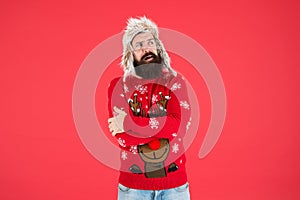 Stay warm in style. Bearded man feel cold red background. Hipster shiver of cold. Festive fashion trends for cold