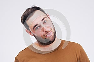 Stay weird. Studio shot of a young man making a funny face against a gray background.