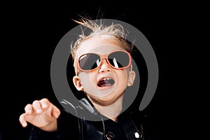 Stay wild and free. Little child boy in rocker jacket and sunglasses. Little rock star. Rock style child. Rock and roll