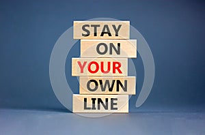 Stay in your own line symbol. Concept words Stay in your own line on wooden blocks. Beautiful grey table grey background. Business