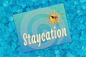 Staycation word message on teal greeting card