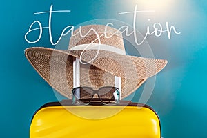 Staycation word with suitcase