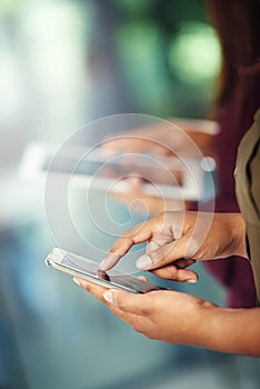 Staying connected. two unrecognisable people using their digital devices.