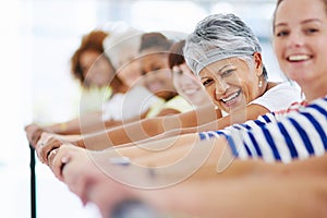 Staying happy and healthy. Shot of a group of women working out indoors.