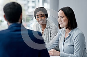 Staying receptive to each others ideas. a businesswoman having a meeting with her colleagues in an office.