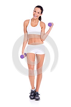 Staying toned and looking amazing. Studio shot of an attractive young woman lifting dumbbells isolated on white.