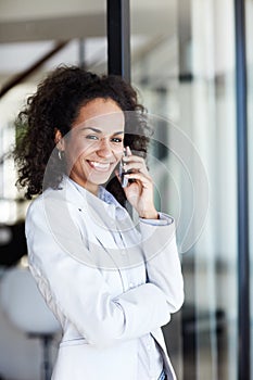 Staying in touch. an attractive young businesswoman making a call on her mobile phone.