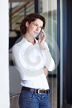 Staying in touch with clients and colleagues. an attractive young businesswoman making a call on her mobile phone.