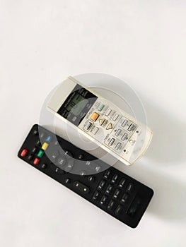 stb remote for tv and ac remote on white background