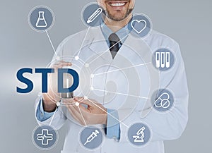 STD prevention. Closeup view of doctor with drug, abbreviation and different icons on light background