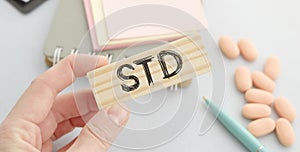 STD text on wooden cube. Medical