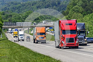 A steady flow of semis lead the way down a busy interstate highway in Tennessee