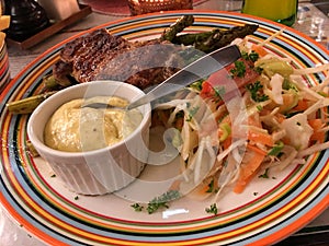 Steak with aspargus, mixed sallad and bernaise sause on colorful plate