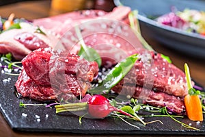 Steak.Beef steak.Meat.Portioned meat.Raw fresh meat.Sirloin steak.T-Bone steak. Flank steak. Duck breast. Vegetable decoration.