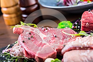 Steak.Beef steak.Meat.Portioned meat.Raw fresh meat.Sirloin steak.T-Bone steak. Flank steak. Duck breast. Vegetable decoration.