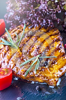 Steak chicken breast olive oil cherry tomatoes pepper and rosemary herbs.