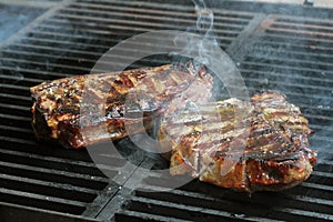 Steak cooking on flame grill