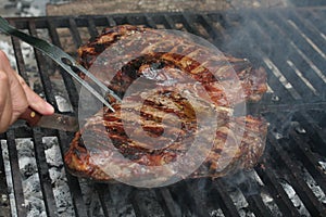Steak cooking on flame grill