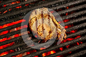 Steak cooking over flaming grill