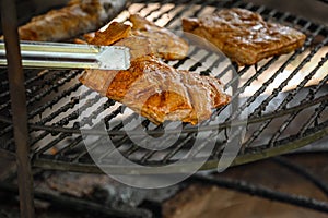 Steak cooking over flaming grill