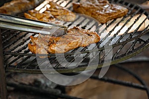 Steak cooking over flaming grill