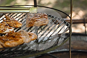 Steak cooking over flaming grill