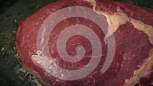 Steak cooking - prime cut sizzling in pan