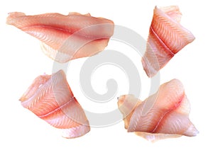 A steak of flying fish falls into the pan. The effect of flying motion in the cooking process.Isolated objects on a white