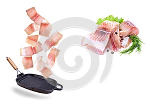 A steak of flying fish falls into the pan. The effect of flying motion in the cooking process.Isolated objects on a