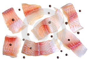 A steak of flying fish falls into the pan. The effect of flying motion in the cooking process.Isolated objects on a