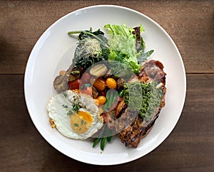 Steak fried egg saute vegetables