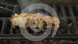 Steak on the grill, the chef turns a large juicy and thick piece of beef, lamb or pork meat on the grill, macrocosm of a