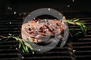 Steak on the grill with flames. raw beef steak on a BBQ grill. banner, menu, recipe place for text, top view