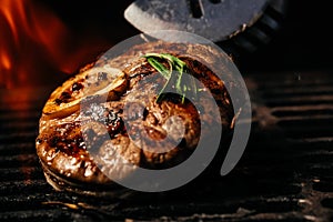 Steak on the grill with flames. raw beef steak on a BBQ grill. banner, menu, recipe place for text, top view