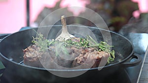 Steak and herbs on pan.