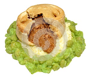 Steak And Kidney Pudding With Mashed Potato And Peas