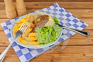 Steak And Kidney Pudding Meal With Chips And Mushy Peas