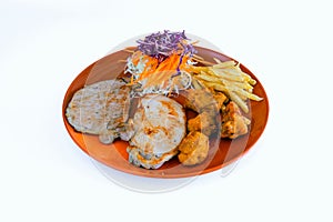 Steak pork chop with fried chicken,french fries and vegetable salad on dish with white background. Meat steak and french fries