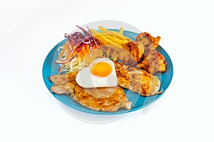 Steak pork chop with fried egg and nugget and sausage with french fries and vegetable salad on dish with white background. Meat