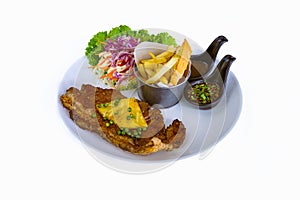 Steak pork chop topped with pineapple and pepper sauce with french fries and vegetable salad put in dish on white background. Meat