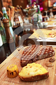 Steak with potato with corn and red wine