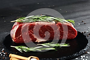 Steak raw. Barbecue Rib Eye Steak or rump steak on dark rustic table