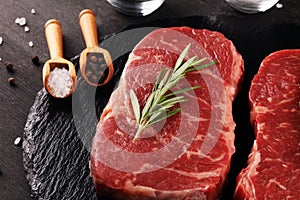 Steak raw. Barbecue Rib Eye Steak or rump steak on dark rustic table