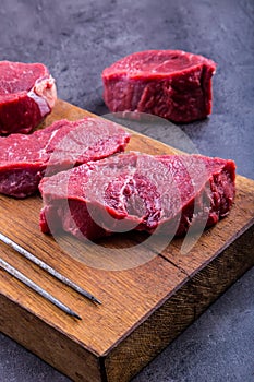 Steak. Raw beef steak. Fresh raw Sirloin beef steak sliced o Herb - Rosemary decoration