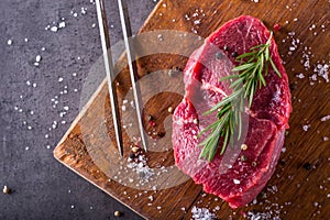 Steak. Raw beef steak. Fresh raw Sirloin beef steak sliced o Herb - Rosemary decoration